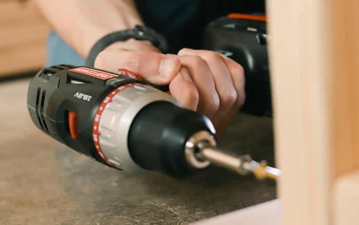 Furniture being assembled with a cordless drill